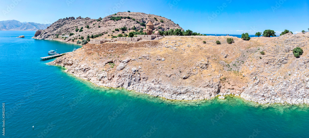 Aerial view of Akdamar Holy Cross Church, hidden monuments of Anatolia. Island of Akdamar on lake Van, eastern Turkey. Akdamar Church is remarkable fo its exceptionally rich stone reliefs