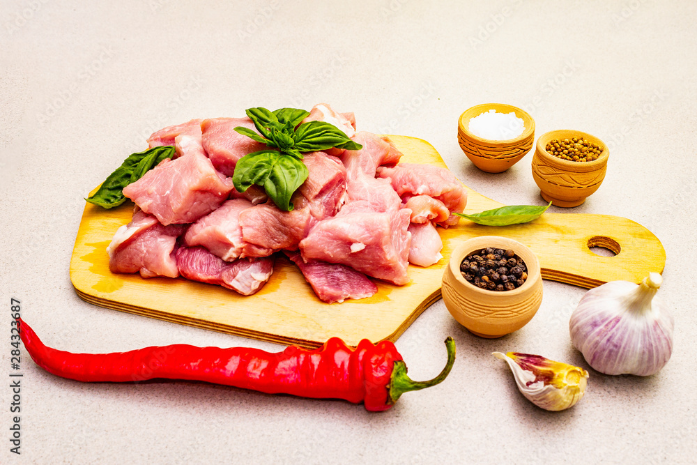 Raw pork neck, cut into pieces with fresh vegetables and dry spice Raw pork neck, cut into pieces with fresh vegetables and dry spice