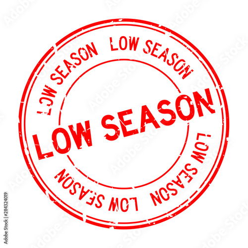 Grunge red low season word round rubber seal stamp on white background
