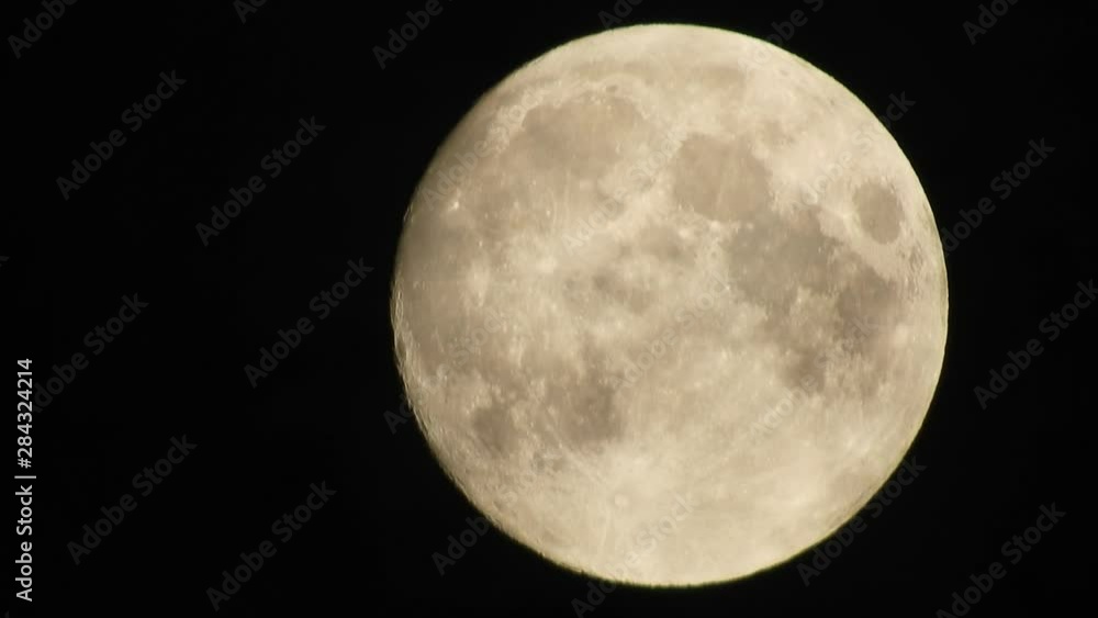 Full moon and clouds on a summer night sky. Moon With Clouds In The Night Sky. Full moon shining through the clouds Full moon and clouds on a summer night sky. Moon With Clouds In The Night Sky. Full moon shining through the clouds