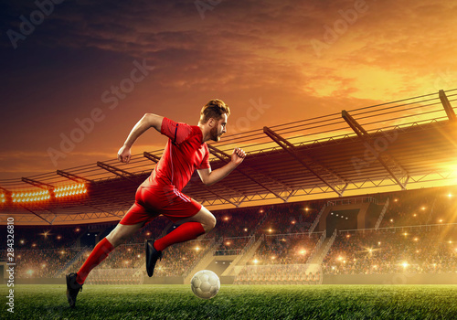 Soccer player in action on a stadium. Dribble the ball. Soccer game. Sports championship. Soccer field.