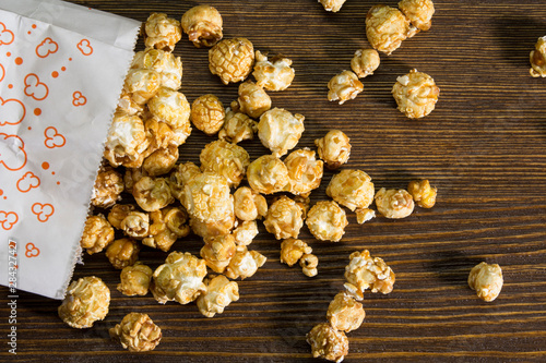 Corn popcorn in a bag on a wooden background