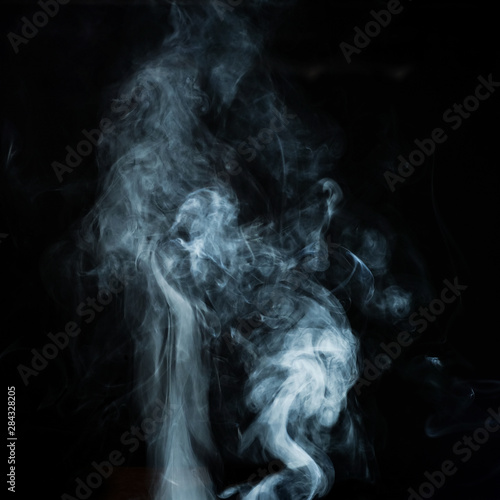 Abstract white smoke effect isolated on black background.