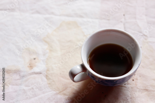 black coffee with stain on fabric from drinking 