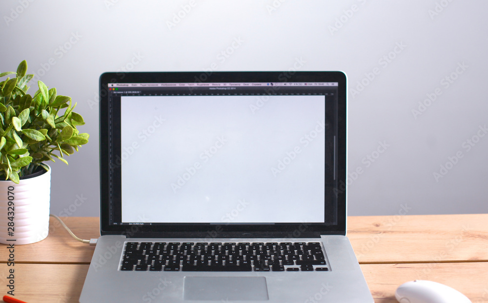 Fototapeta premium Laptop stands on a wooden table in office
