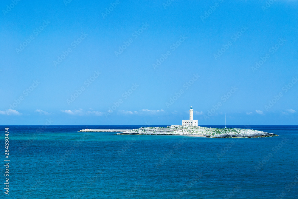 Vieste, Gargano, Apulia. lighthouse on the island in the middle of the bay. Mediterranean sea