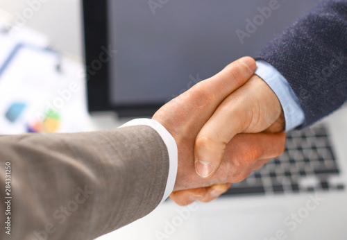 Business handshake. Two businessman shaking hands with each oth photo