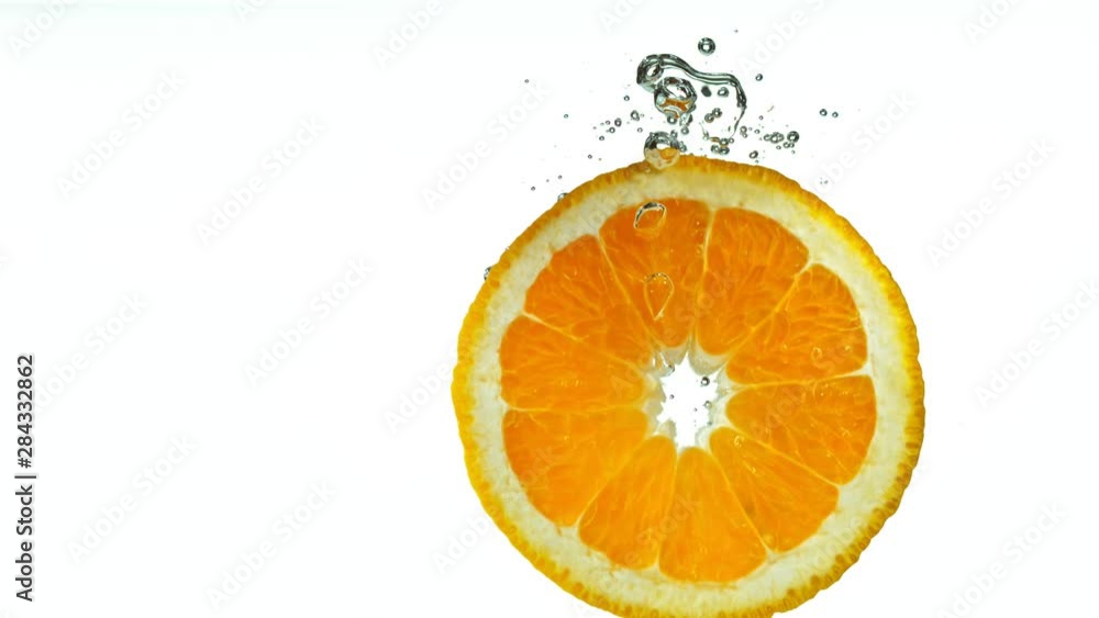 Super Slow Motion Shot of Falling Orange Slice into Water at 1000fps. Shooted with High Speed Cinema Camera at 4K Super Slow Motion Shot of Falling Orange Slice into Water at 1000fps. Shooted with High Speed Cinema Camera at 4K