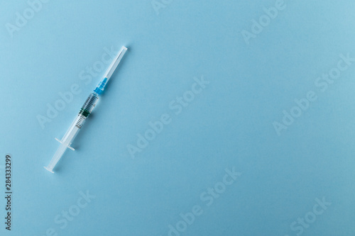 Syringe on a blue background