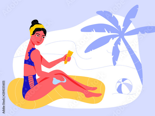 Beautiful young woman in navy high waist swimsuit uses sunscreen on a beach during vacation travel. Skin care to get nice tan, protect it from UV rays and prevent dermatological diseases.