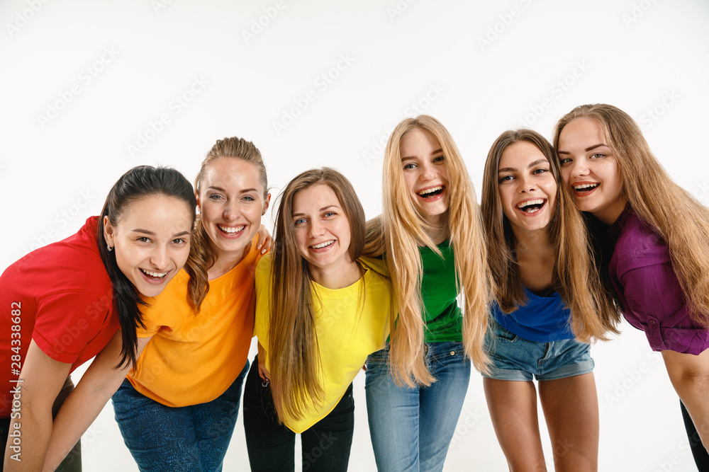 Young women weared in LGBT flag colors isolated on white background. Caucasian female models in bright shirts. Look happy, smiling. Trust LGBT pride, human rights, freedom of choice concept. Young women weared in LGBT flag colors isolated on white background. Caucasian female models in bright shirts. Look happy, smiling. Trust LGBT pride, human rights, freedom of choice concept.
