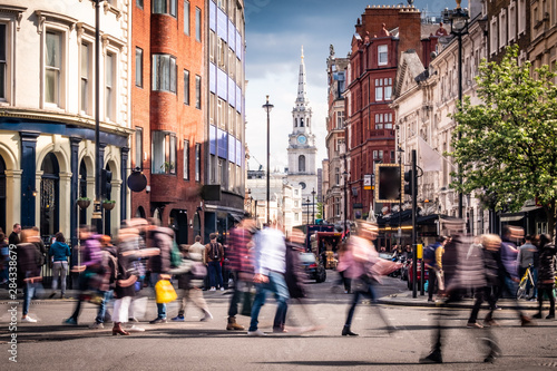 Motion blurred people on busy street in London's West End, UK