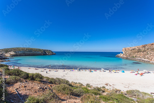 Lampedusa Island Sicily - Rabbit Beach with no people and Rabbit Island Lampedusa    Spiaggia dei Conigli    with turquoise water white sand at paradise beach.