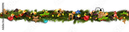 Christmas border (Weihnachten Girlande) with fir branches, pine cones, holly, and string lights. Merry Christmas background with open space for your text.
