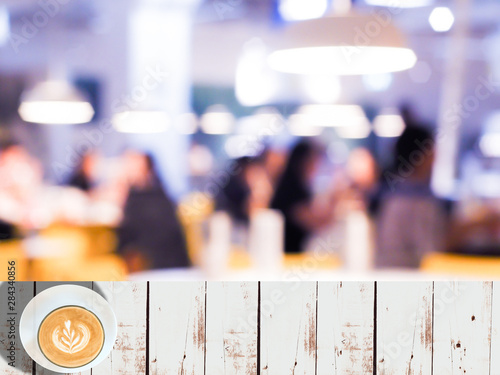Empty white wooden table space platform with Vintage tone abstract blur image of Cafe or Restaurant on night time with bokeh for background usage
