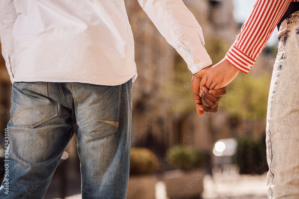 Two people holding hands outdoors stock photo