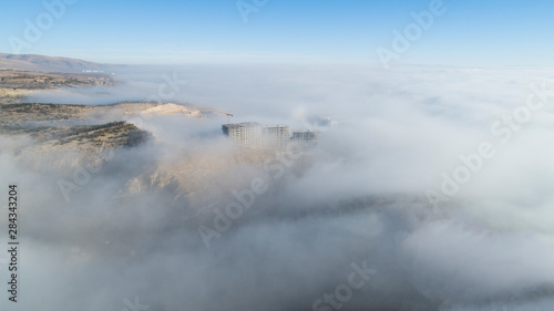 Aerial view of the buildings in fog