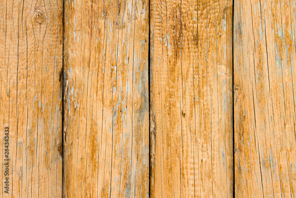 Old wooden boards with peeling paint. Wooden fence. Grunge style.