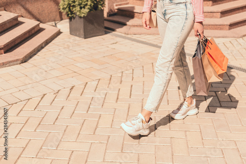 Lady in jeans walking with shopping bags stock photo © shevchukandrey