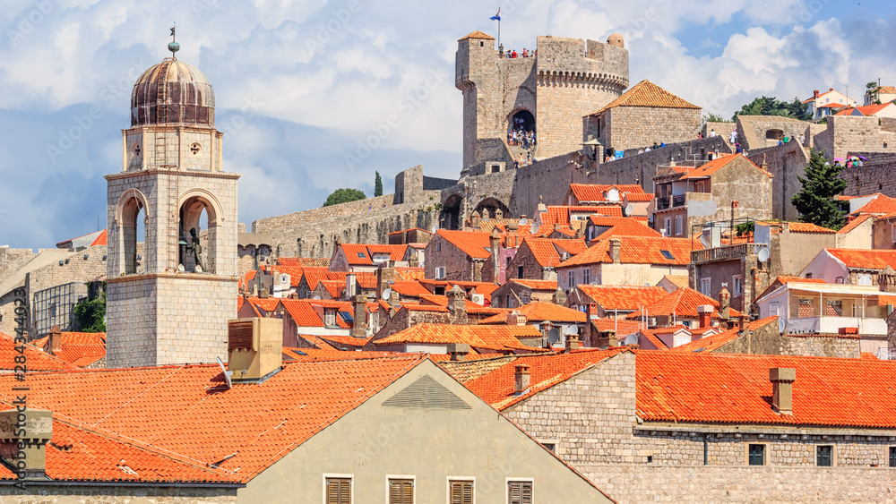 Summer mediterranean cityscape - view of the roofs of the Old Town of Dubrovnik on the background on of the city walls and of the Minceta Tower, Adriatic coast of Croatia