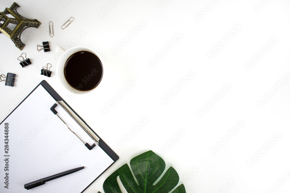 Top view of the clipboard with paper, leaves and accessories working. Flat lay. Top view of the clipboard with paper, leaves and accessories working. Flat lay.
