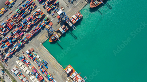 Container ship in export and import business logistics and transportation. Cargo and container box shipping to harbor by crane. Water transport International. Aerial view and top view. © MAGNIFIER
