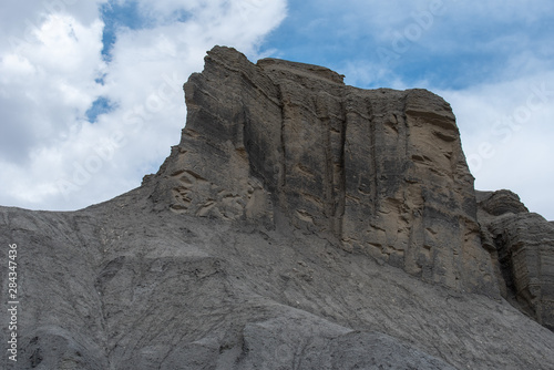Low angle view of dark grey barren rock formation near Hanksville, Utah