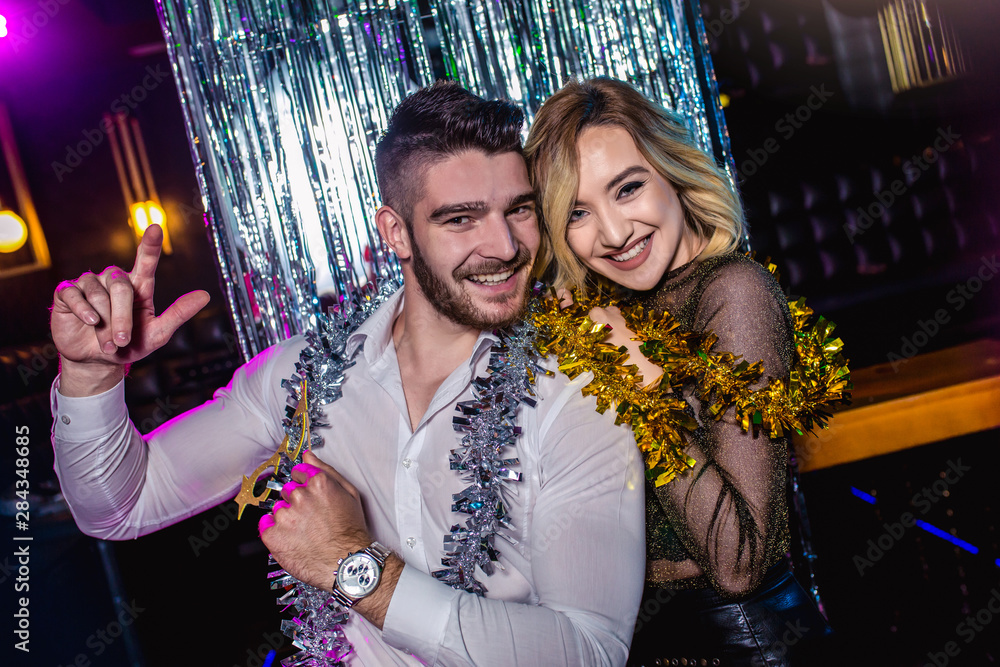 Romantic young couple having fun in the night club. Man and woman in the pub. Romantic young couple having fun in the night club. Man and woman in the pub.
