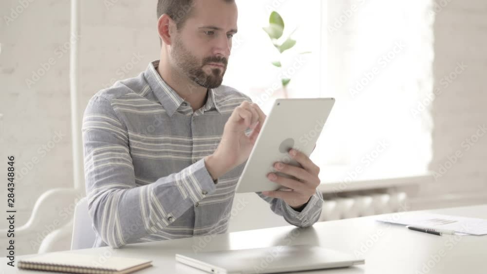 Adult Young Man Using Digital Tablet Adult Young Man Using Digital Tablet