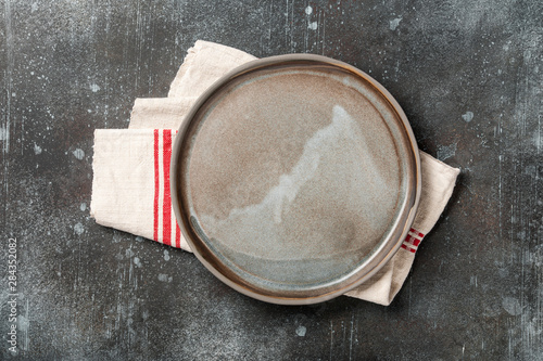Rustic ceramic plate on rusty metal background