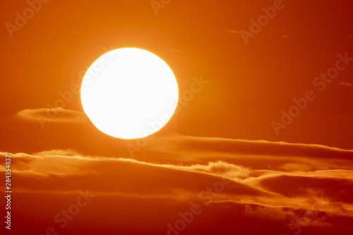 Fototapeta Naklejka Na Ścianę i Meble -  Large Sun on Orange Clouds at Sunset