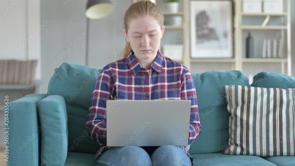 Young Woman Sitting on Couch And Using Laptop Young Woman Sitting on Couch And Using Laptop