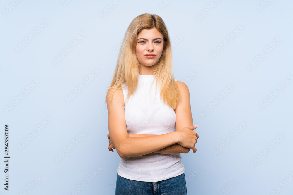 Teenager girl over isolated blue background with surprise facial expression Teenager girl over isolated blue background with surprise facial expression