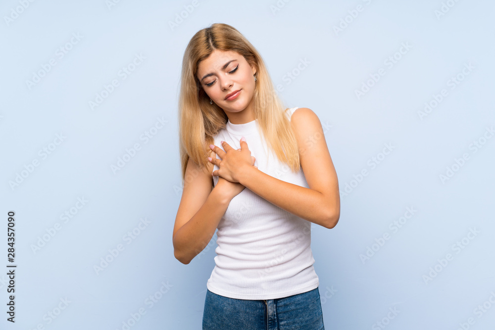 Teenager girl over isolated blue background showing and lifting a finger Teenager girl over isolated blue background showing and lifting a finger