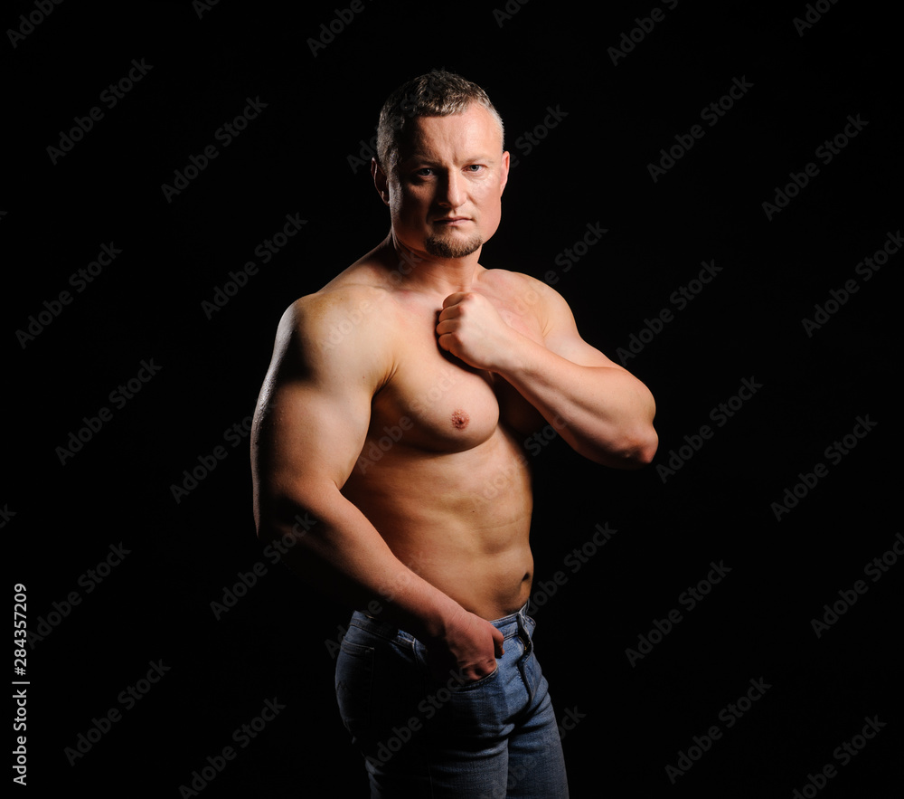 Fototapeta premium Image of muscle man posing in studio
