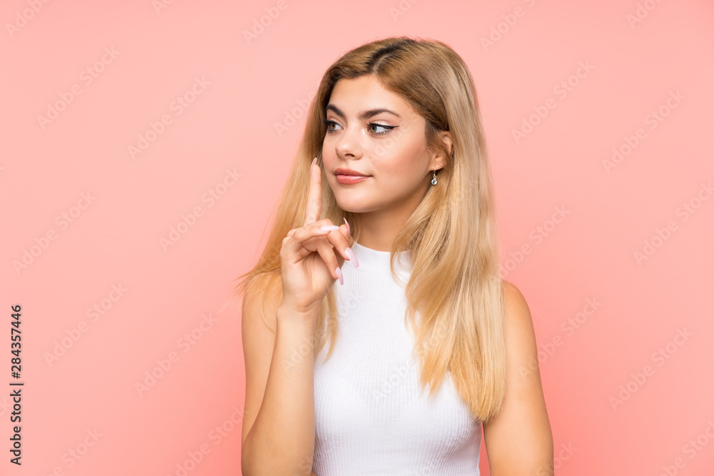Teenager girl over isolated pink background doing silence gesture Teenager girl over isolated pink background doing silence gesture