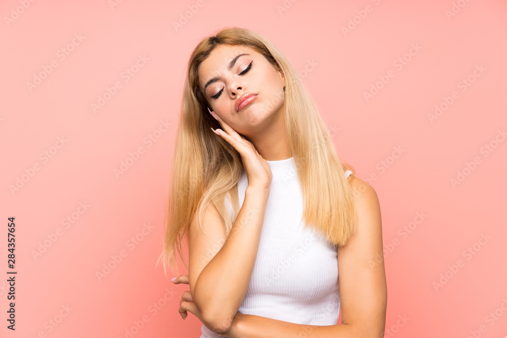Teenager girl over isolated pink background unhappy and frustrated Teenager girl over isolated pink background unhappy and frustrated