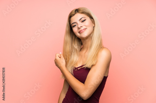 Wallpaper Mural Teenager girl over isolated pink background celebrating a victory Torontodigital.ca