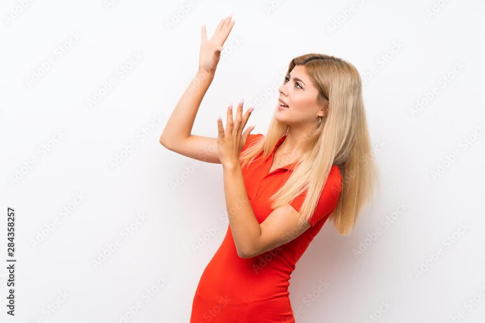 Fototapeta premium Teenager girl over isolated white background nervous and scared