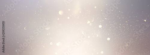 blackground of abstract glitter lights. silver and gold. de-focused. banner