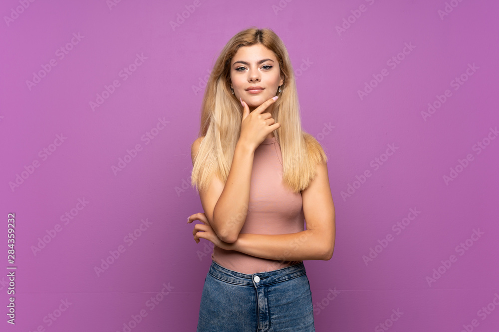 Teenager girl over isolated purple background thinking Teenager girl over isolated purple background thinking
