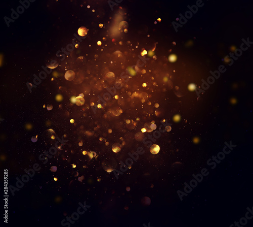 blackground of abstract glitter lights. blue, gold and black. de focused