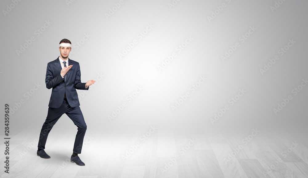 Young businessman in suit fighting in an empty space Young businessman in suit fighting in an empty space