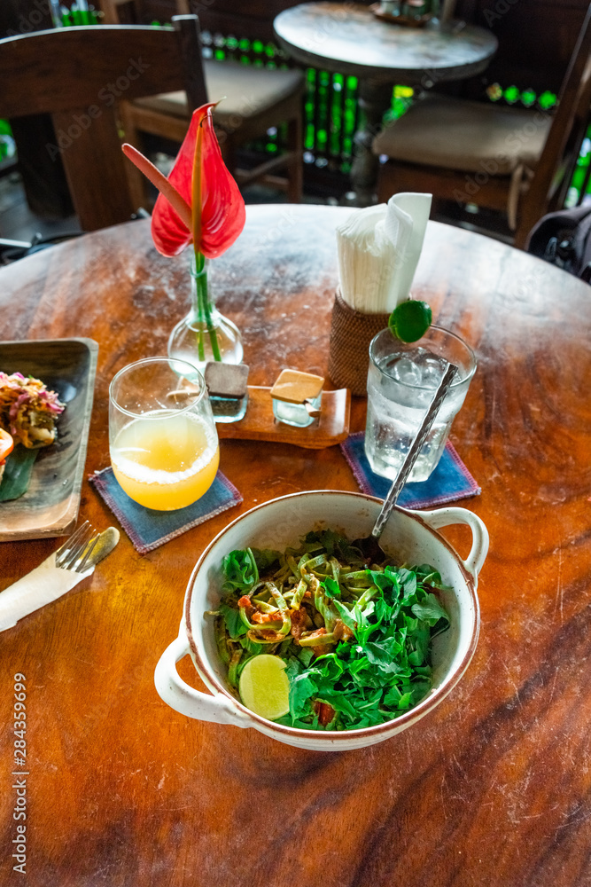 Board with tasty vegetarian pasta on wooden table Board with tasty vegetarian pasta on wooden table