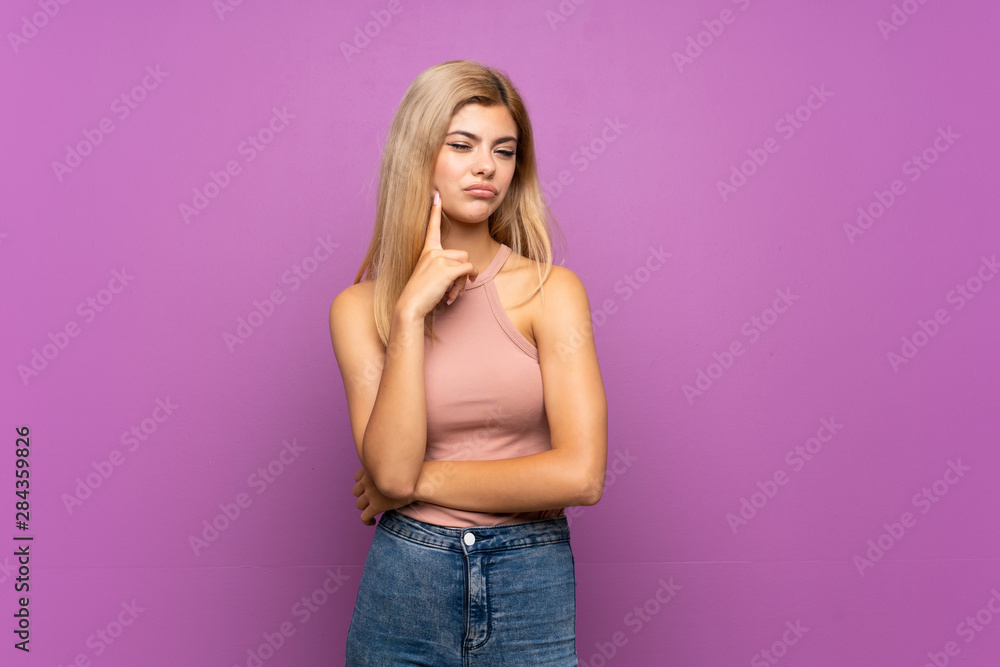 Teenager girl over isolated purple background Looking front Teenager girl over isolated purple background Looking front