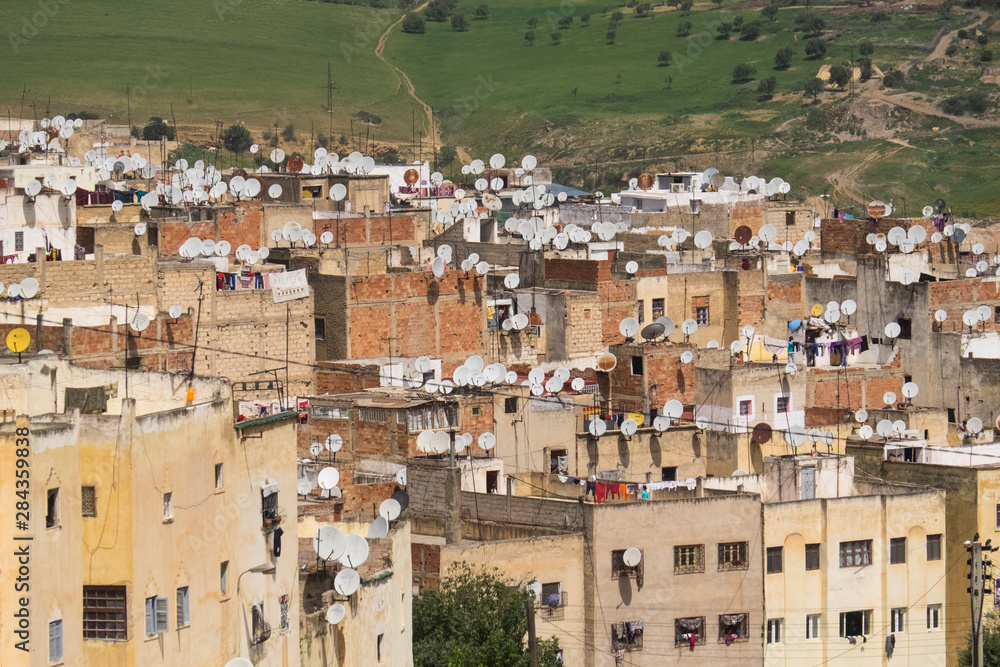 Obraz premium Morocco, Fes. City buildings loaded with satellite dishes.