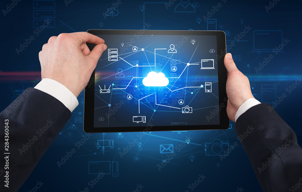 First person view of a hand using tablet with cloud office concept First person view of a hand using tablet with cloud office concept