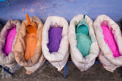 Africa, Morocco, Chechaouen, containers of colorful pigments, powders or dyes on historical village street. photo