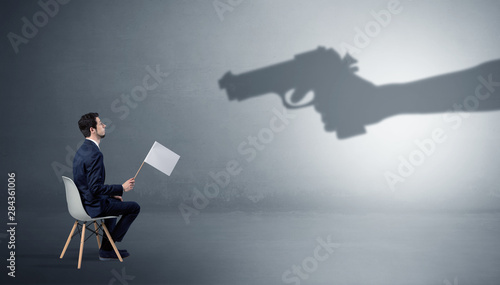 Photography Small businessman staying and offering stuffs for an armed shadow hand