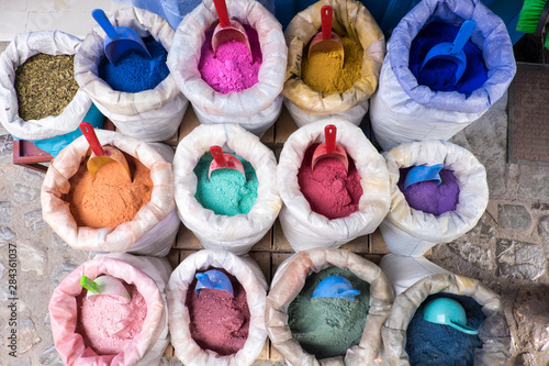 Morocco, Chefchaouen or Chaouen is most noted for its small narrow streets and neighborhoods painted in variety of vivid blue colors. Bags of colorful paint pigments. © Emily Wilson/Danita Delimont
